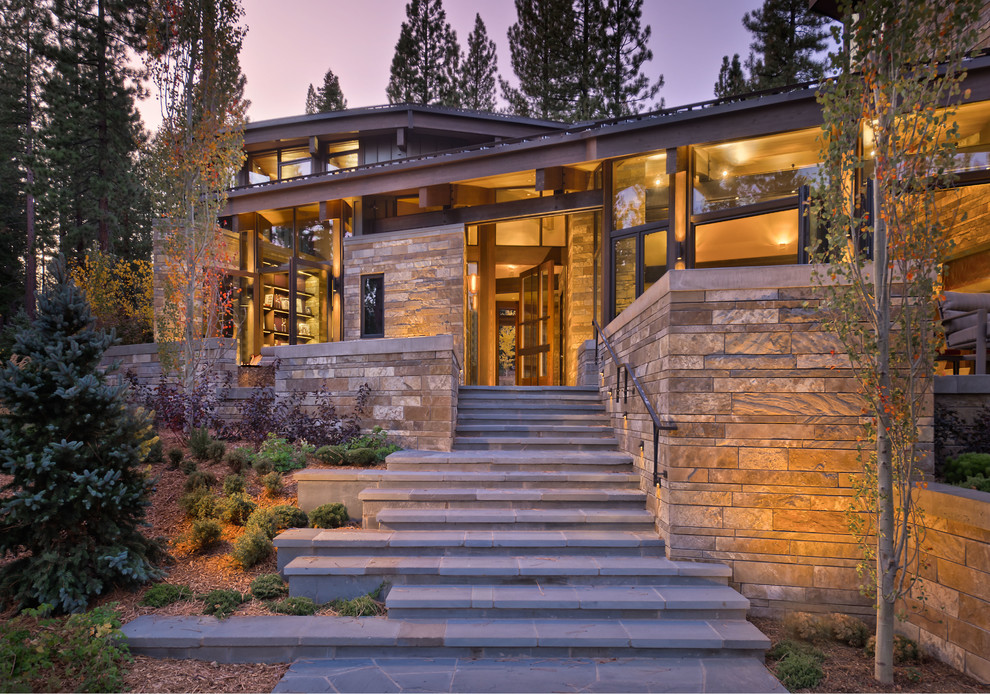 Inspiration for a mid-sized contemporary two-storey beige exterior in Sacramento with stone veneer and a shed roof.