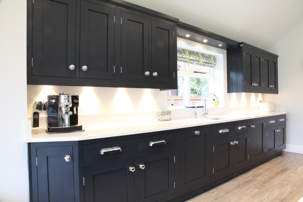 This is an example of a large contemporary eat-in kitchen in Other with an undermount sink, shaker cabinets, grey cabinets, quartzite benchtops, white splashback, stainless steel appliances and with island.