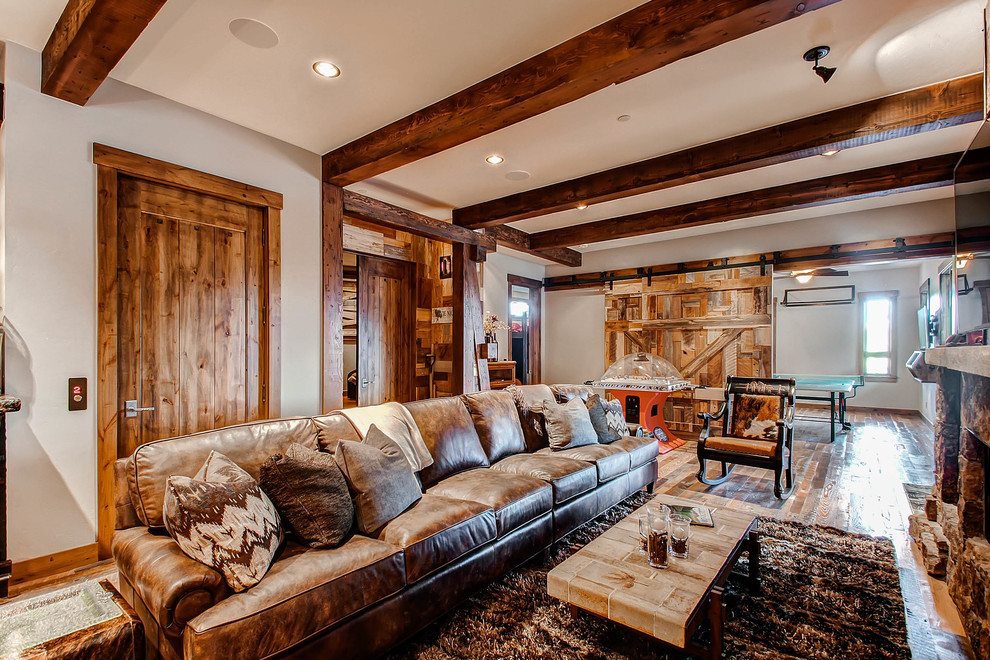 Country open concept family room in Denver with a game room, beige walls and dark hardwood floors.