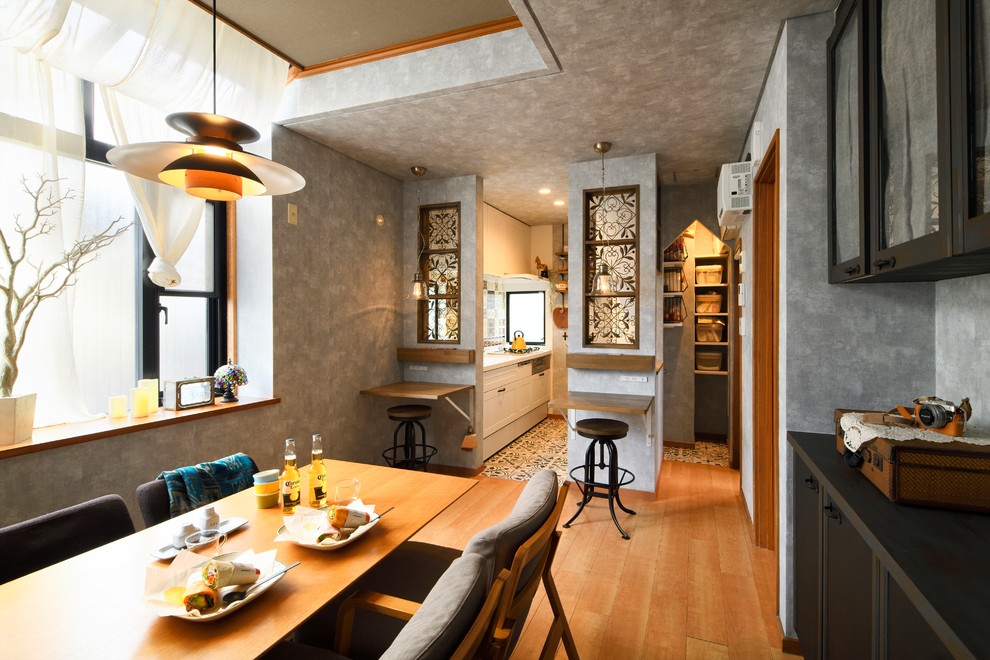 Inspiration for a small asian open plan dining in Other with grey walls, medium hardwood floors and brown floor.