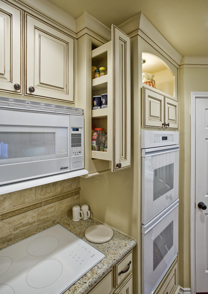 Traditional kitchen in Dallas with white appliances.
