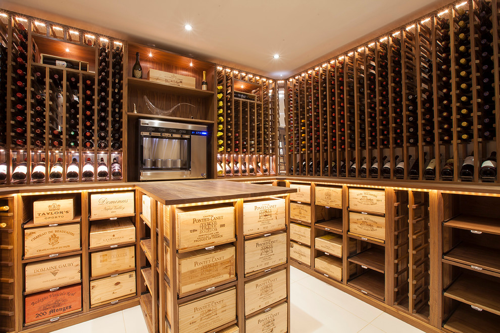 Inspiration for a traditional wine cellar in London with display racks and white floor.