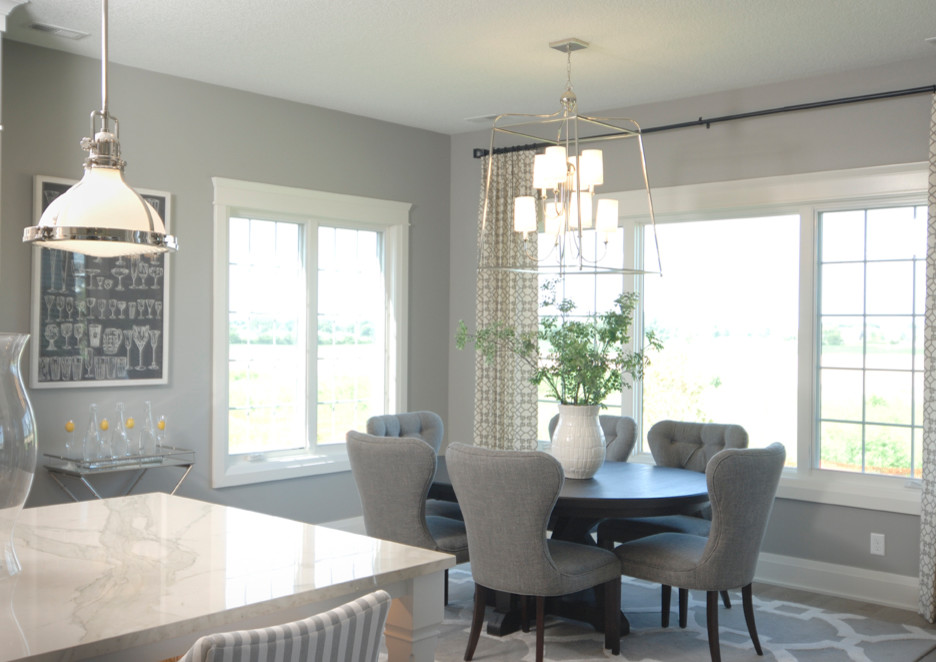 Example of a mid-sized transitional light wood floor kitchen/dining room combo design with gray walls and no fireplace