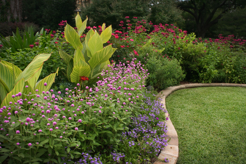 Large traditional front yard full sun formal garden in Dallas with brick pavers for summer.