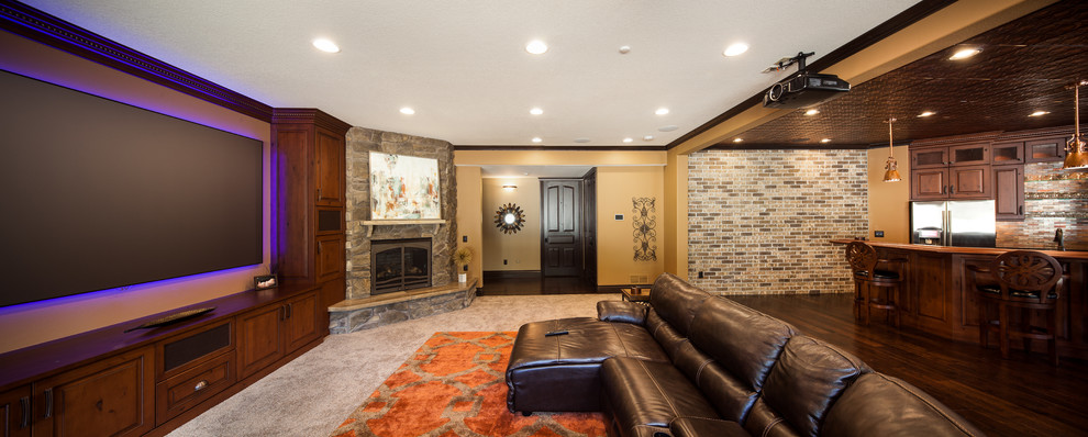 Design ideas for a large arts and crafts fully buried basement in Chicago with brown walls, dark hardwood floors, a standard fireplace and a stone fireplace surround.