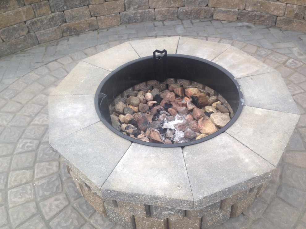 Photo of a mid-sized traditional backyard full sun garden for fall in Omaha with a fire feature and brick pavers.