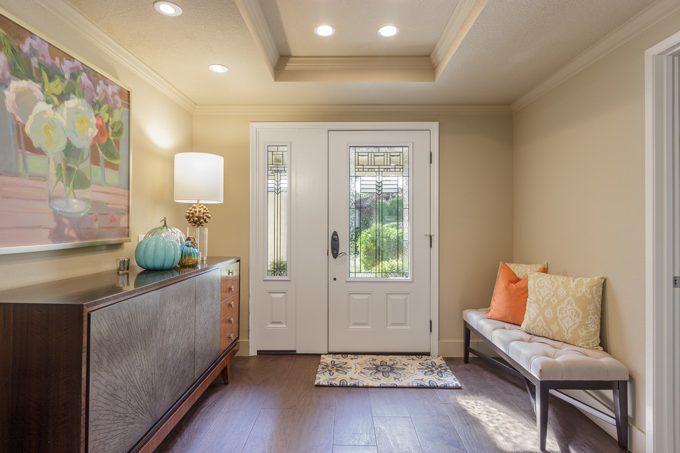 Design ideas for a mid-sized transitional foyer in Los Angeles with beige walls, dark hardwood floors, a single front door, a white front door and brown floor.