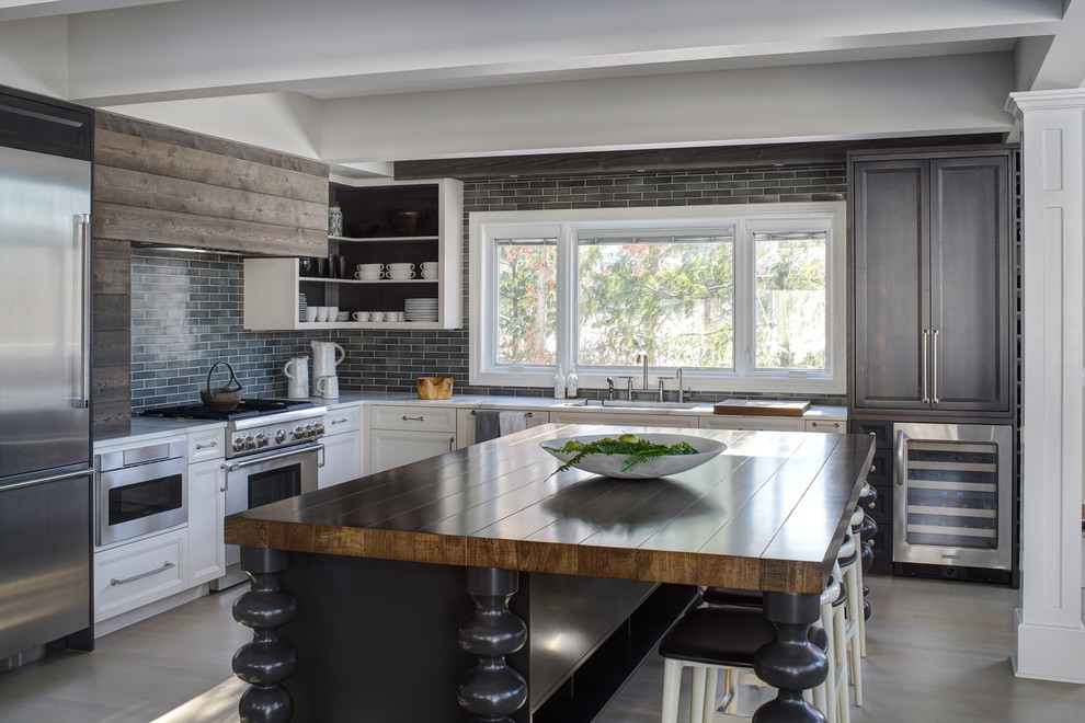 Inspiration for a large transitional light wood floor kitchen remodel in Chicago with a farmhouse sink, quartzite countertops, blue backsplash, subway tile backsplash, stainless steel appliances and an island