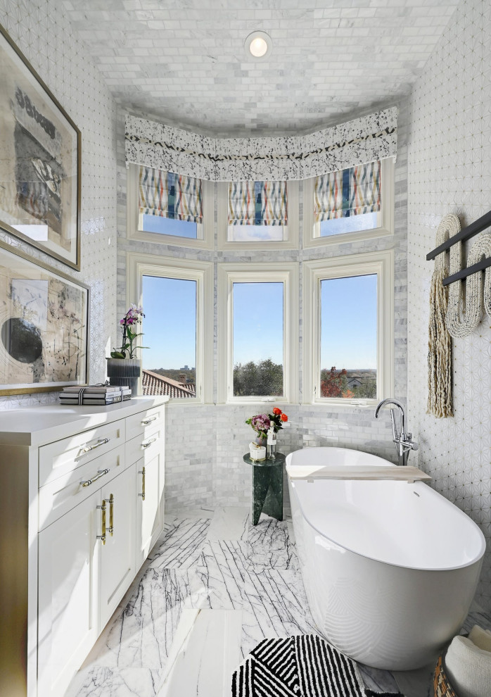Photo of a large modern master bathroom in Austin with raised-panel cabinets, white cabinets, a freestanding tub, a corner shower, a one-piece toilet, multi-coloured tile, marble, multi-coloured walls, marble floors, an undermount sink, marble benchtops, multi-coloured floor, an open shower, multi-coloured benchtops, an enclosed toilet, a double vanity, a built-in vanity, wallpaper and wallpaper.