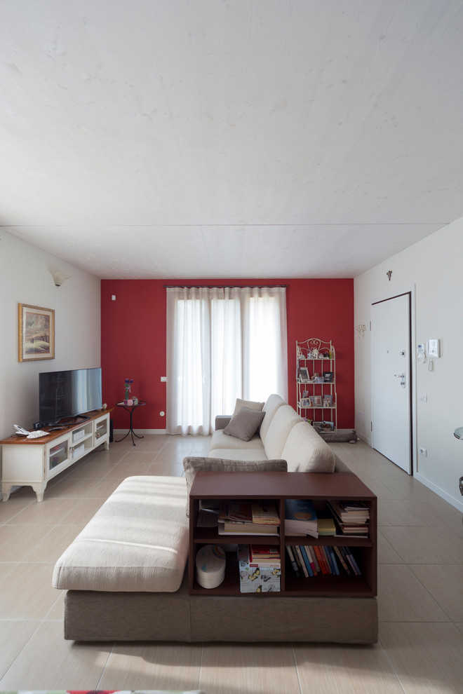 Design ideas for a small eclectic enclosed family room in Milan with red walls, porcelain floors and a wall-mounted tv.