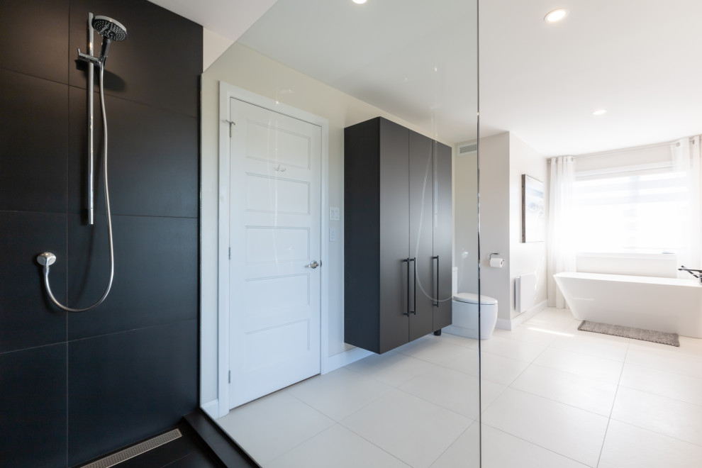 Large transitional master bathroom in New York with flat-panel cabinets, black cabinets, a freestanding tub, a double shower, a one-piece toilet, beige walls, ceramic floors, quartzite benchtops, an open shower, black benchtops, a double vanity and a floating vanity.