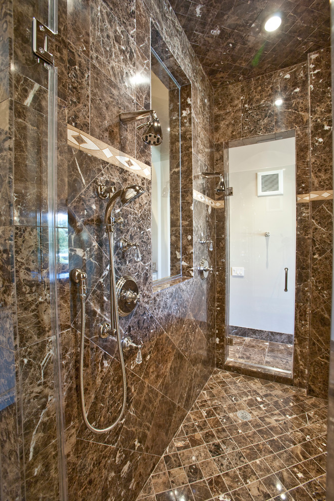 Expansive mediterranean master bathroom in Houston with a drop-in sink, furniture-like cabinets, beige cabinets, marble benchtops, a freestanding tub, an alcove shower, a two-piece toilet, brown tile, stone tile, beige walls and marble floors.