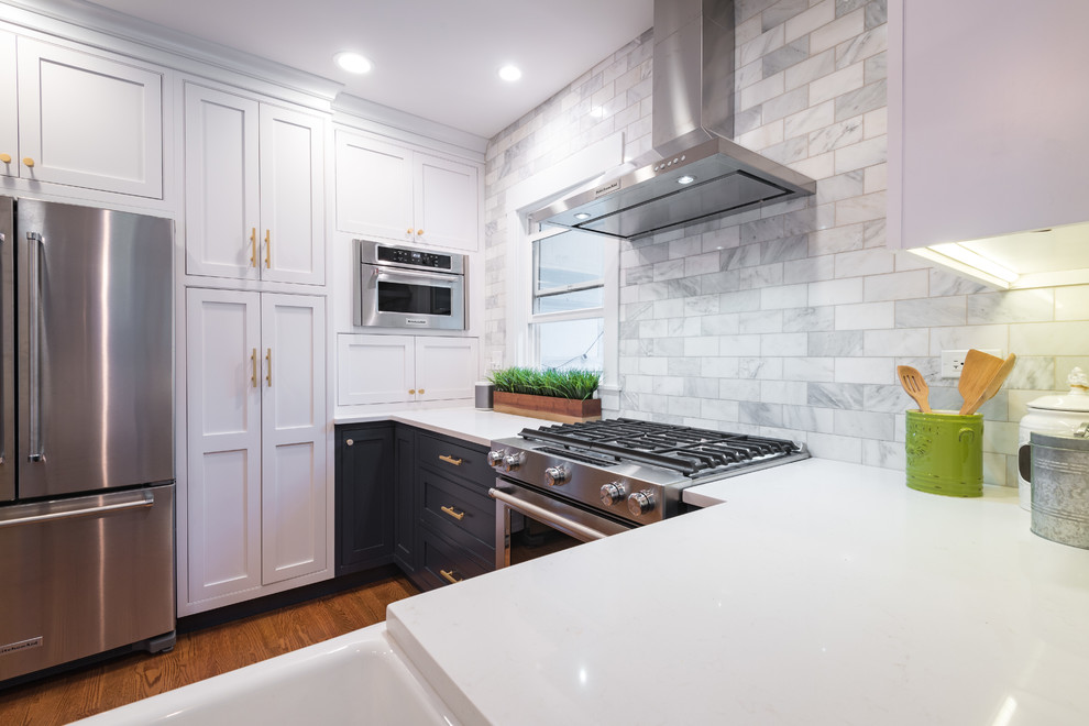 Photo of a small contemporary u-shaped separate kitchen in Chicago with a farmhouse sink, recessed-panel cabinets, white cabinets, quartz benchtops, white splashback, subway tile splashback, stainless steel appliances, medium hardwood floors, no island and brown floor.