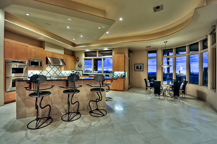 Expansive contemporary separate dining room in Phoenix with beige walls and porcelain floors.