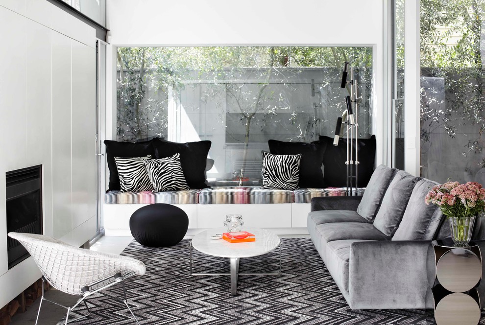 This is an example of a small contemporary living room in Melbourne with white walls and a standard fireplace.