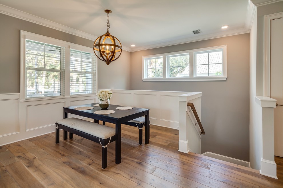 This is an example of a mid-sized transitional separate dining room in Jacksonville with grey walls, medium hardwood floors, no fireplace and brown floor.