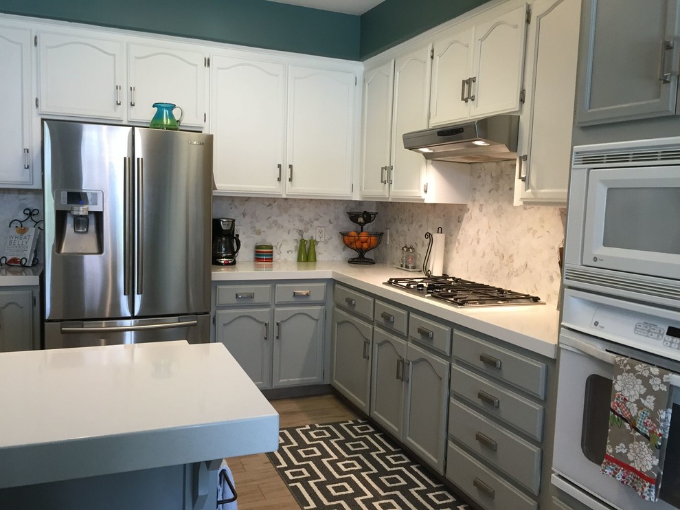 Eat-in kitchen - porcelain tile eat-in kitchen idea with recessed-panel cabinets, gray cabinets, quartz countertops and white backsplash
