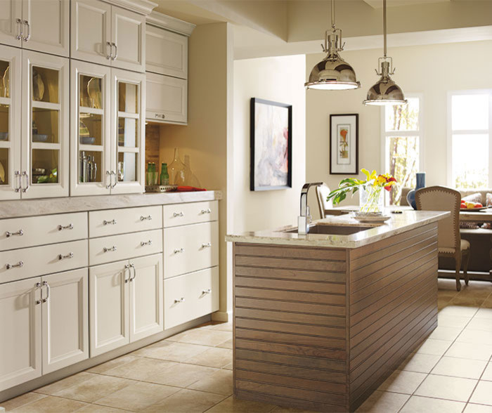 Example of a mid-sized transitional single-wall ceramic tile and white floor eat-in kitchen design in Chicago with an undermount sink, recessed-panel cabinets, white cabinets, beige backsplash, stone tile backsplash, stainless steel appliances, an island and marble countertops
