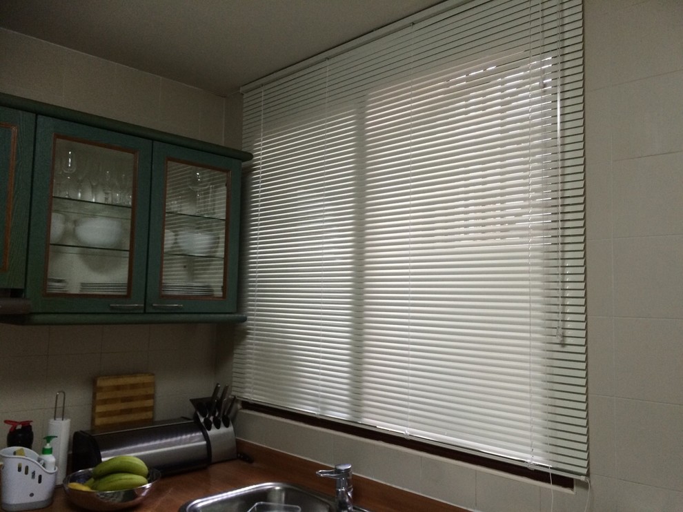 Inspiration for an industrial kitchen pantry in Singapore with glass-front cabinets and green cabinets.