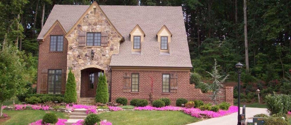 This is an example of a mid-sized full sun front yard driveway.