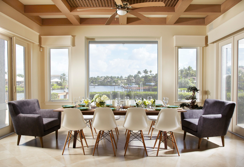 This is an example of a large contemporary dining room in Miami with beige walls and marble floors.