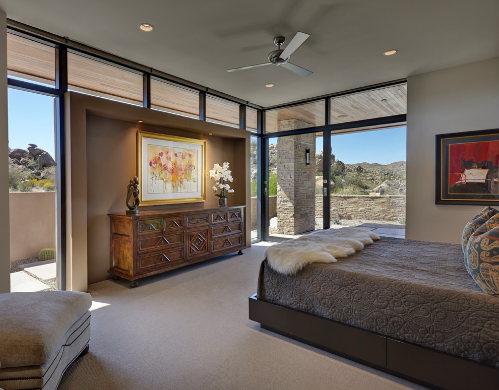 Photo of a mid-sized contemporary master bedroom in Other with beige walls, carpet, no fireplace and beige floor.