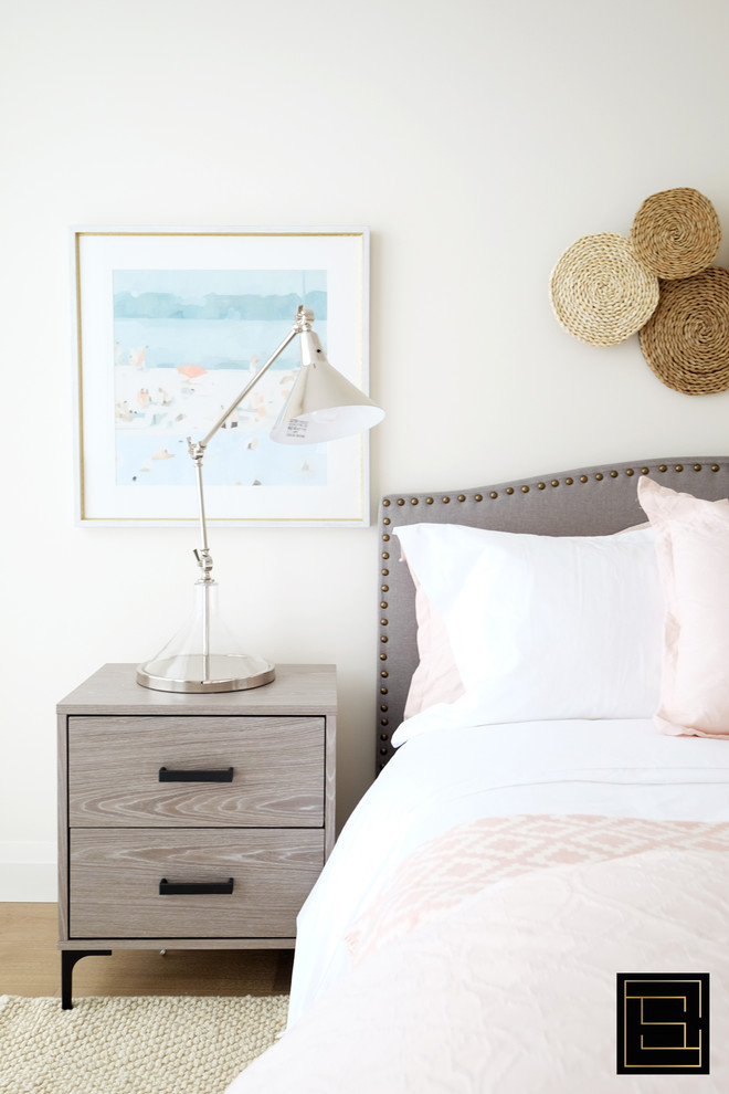Example of a minimalist guest light wood floor bedroom design in Toronto with white walls