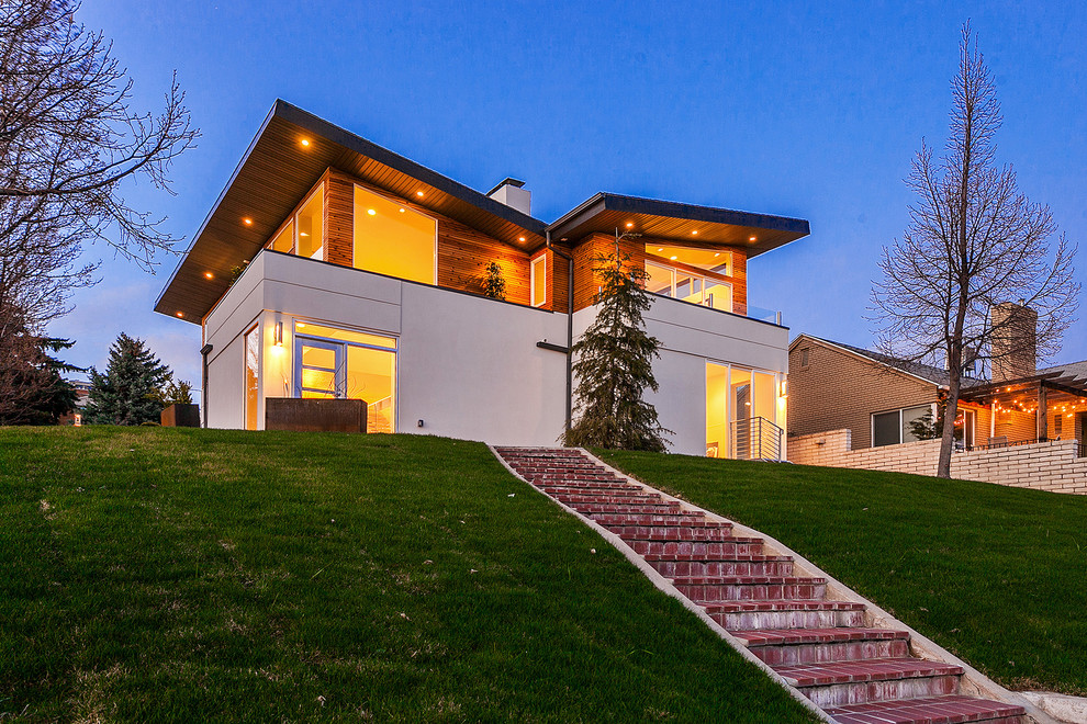 Design ideas for a contemporary two-storey stucco beige exterior in Salt Lake City.