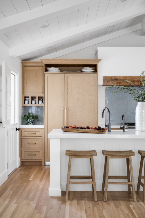 White Quartz Countertops Harmonize with a Blue Terra-Cotta Backsplash and Natural Wood Kitchen Cabinets