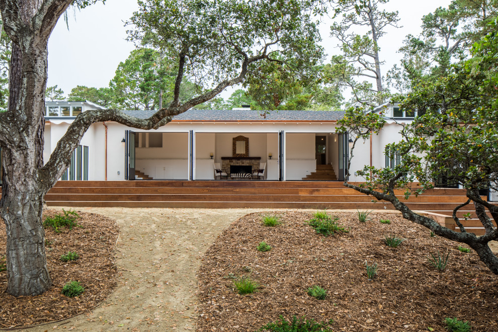 Inspiration for a large transitional beige split-level stucco house exterior remodel with a hip roof and a shingle roof