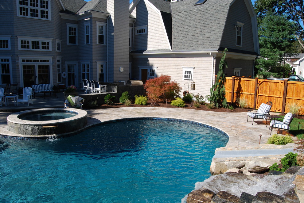 Water slide - mid-sized rustic backyard stone and kidney-shaped natural water slide idea in Boston