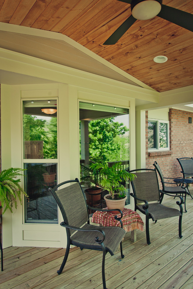 Example of a large transitional backyard patio design in Cincinnati with decking and a roof extension