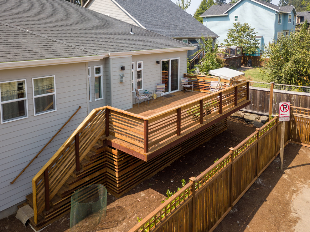 Inspiration for a large transitional backyard deck remodel with no cover