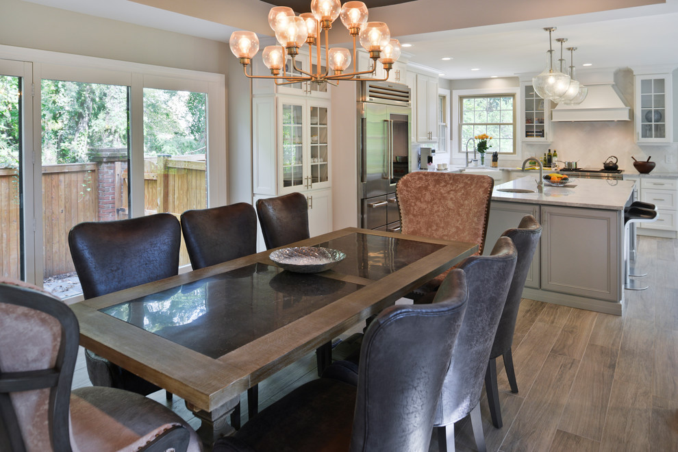 Inspiration for a large transitional kitchen/dining combo in DC Metro with laminate floors and brown floor.