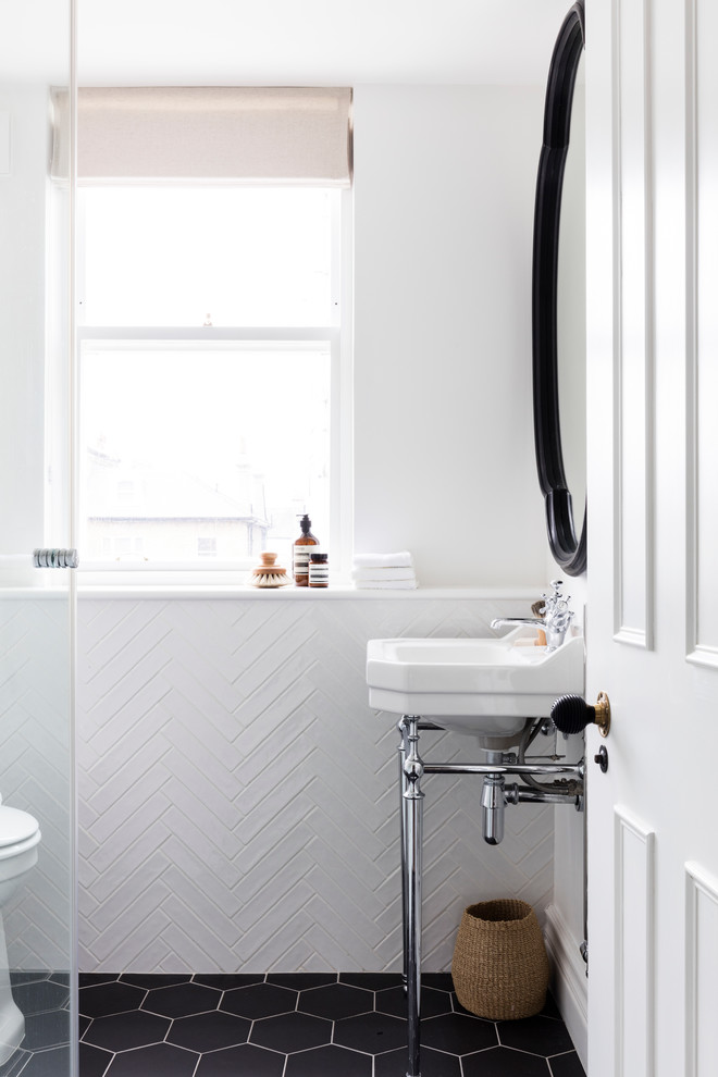 Inspiration for a small scandinavian bathroom in London with flat-panel cabinets, a corner shower, a one-piece toilet, white tile, cement tile, white walls, ceramic floors and a pedestal sink.