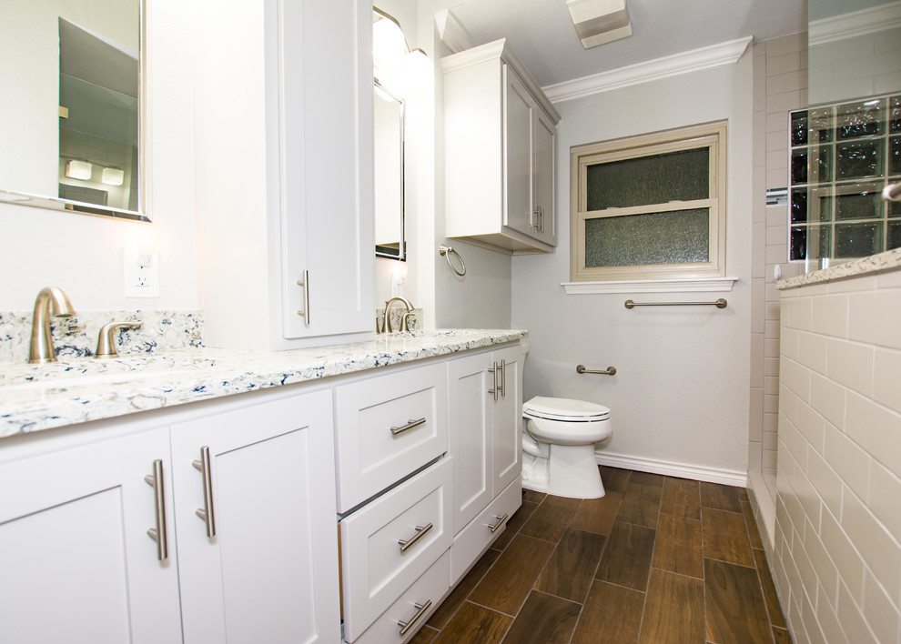 Inspiration for a gray tile and subway tile porcelain tile and brown floor doorless shower remodel in Austin with shaker cabinets, gray cabinets, gray walls, an undermount sink and quartz countertops