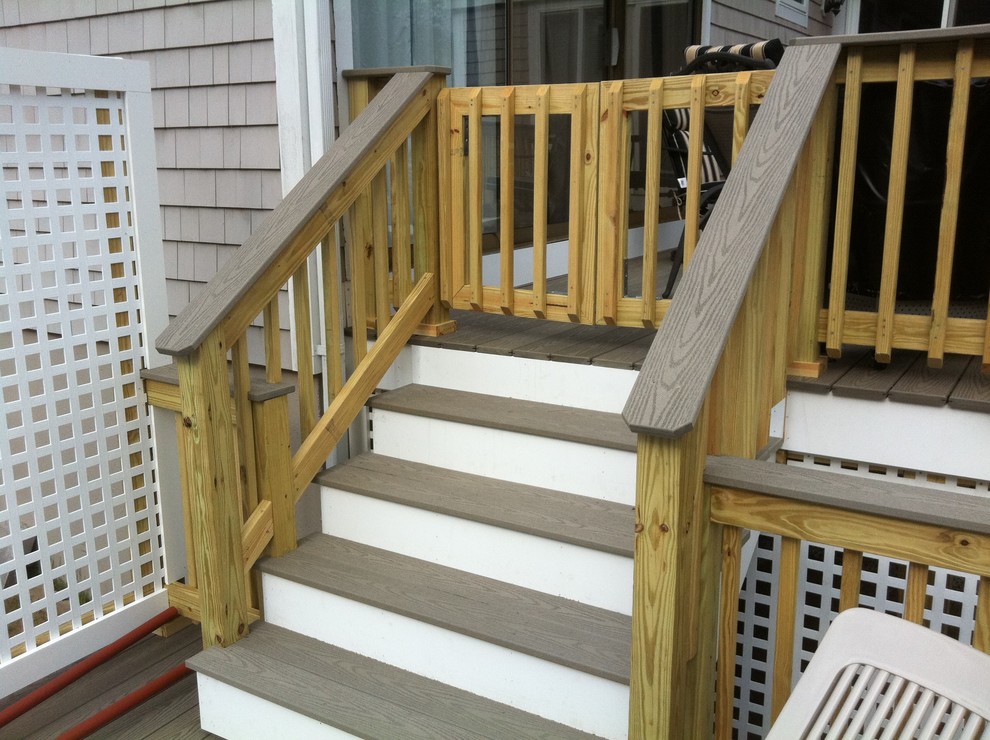 Example of a mid-sized backyard deck design in Boston with no cover