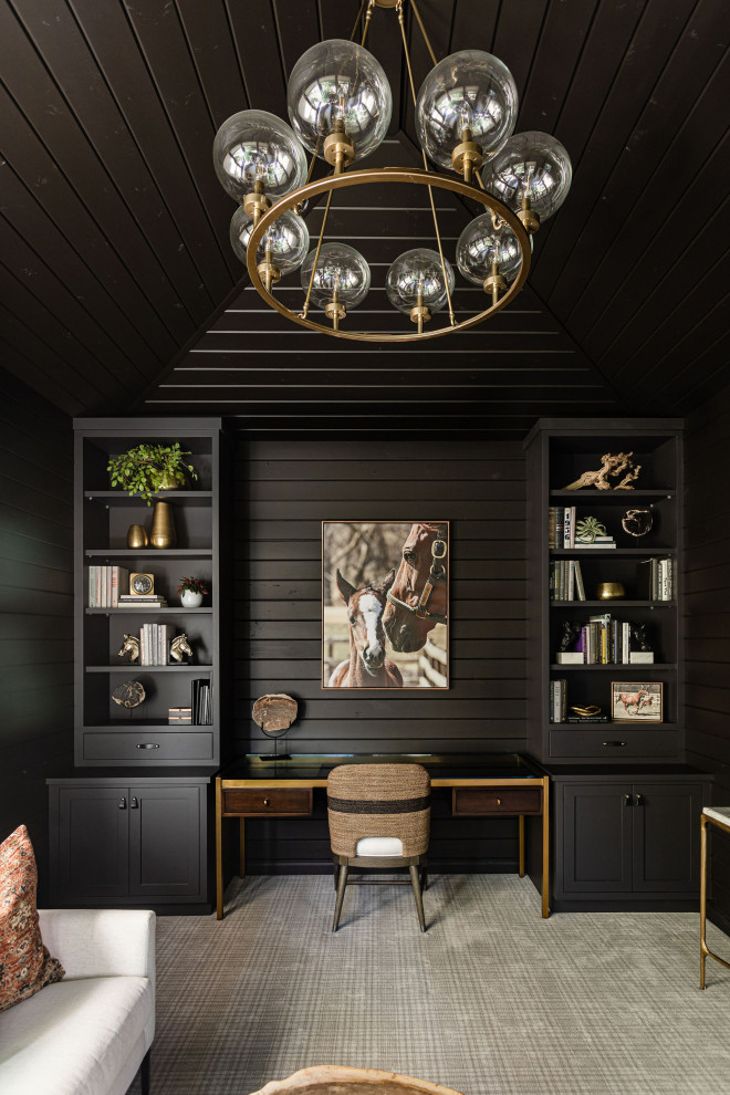This is an example of a small transitional study room in Minneapolis with black walls, carpet, a built-in desk, multi-coloured floor, wood and wood walls.