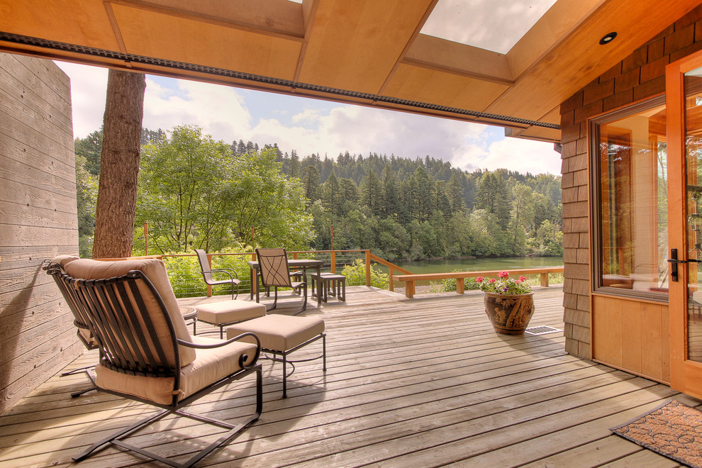 Inspiration for a country deck in Portland with a roof extension.