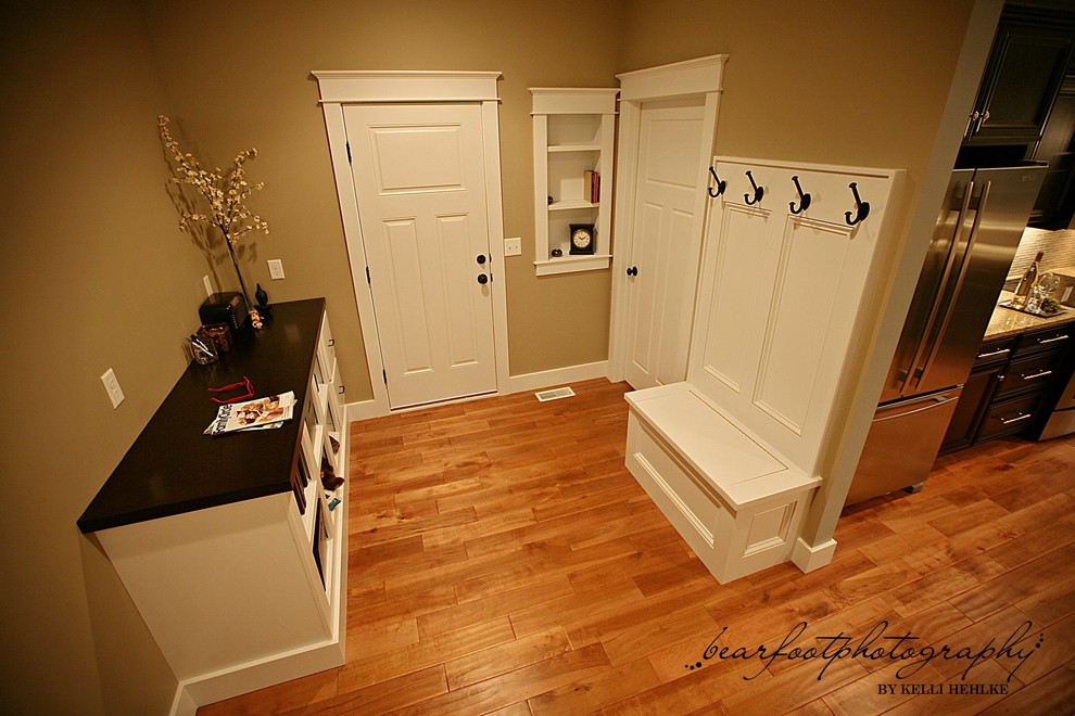 Mid-sized medium tone wood floor mudroom photo in Chicago