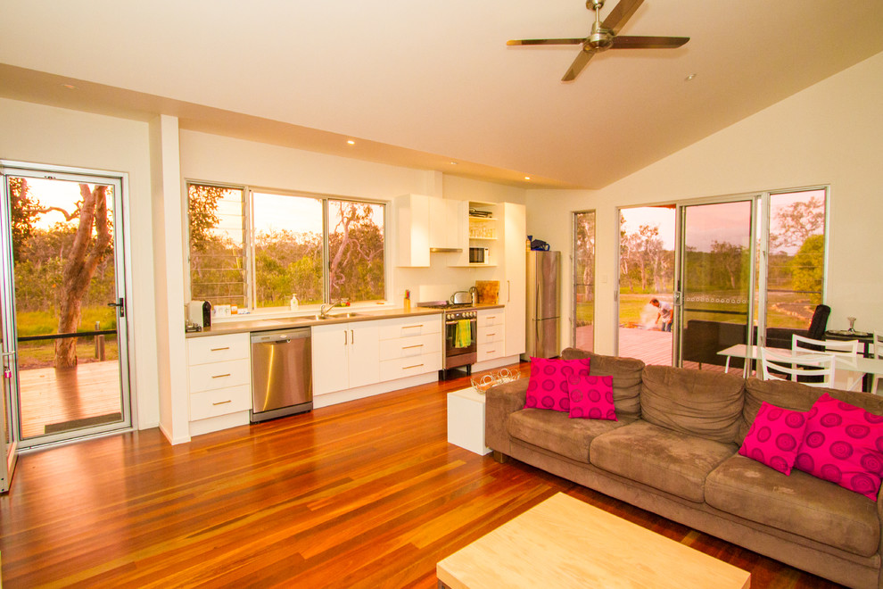 Small contemporary single-wall eat-in kitchen in Sunshine Coast with a double-bowl sink, recessed-panel cabinets, white cabinets, laminate benchtops, white splashback, stainless steel appliances, dark hardwood floors and no island.