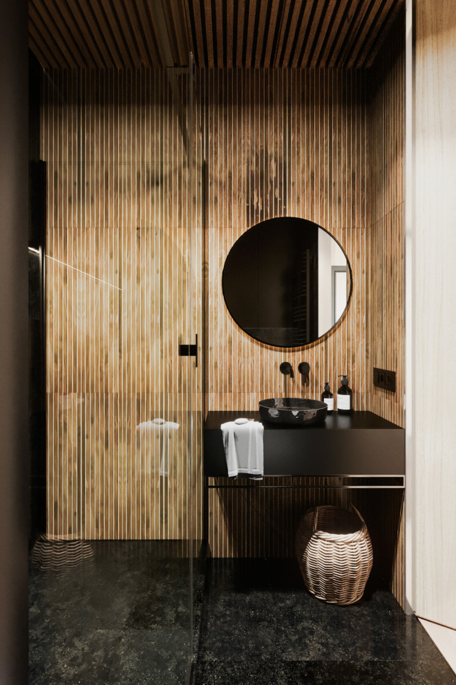 This is an example of a mid-sized contemporary 3/4 bathroom in Valencia with flat-panel cabinets, black cabinets, an open shower, a wall-mount toilet, beige tile, porcelain tile, black walls, porcelain floors, a drop-in sink, solid surface benchtops, black floor, a shower curtain and black benchtops.