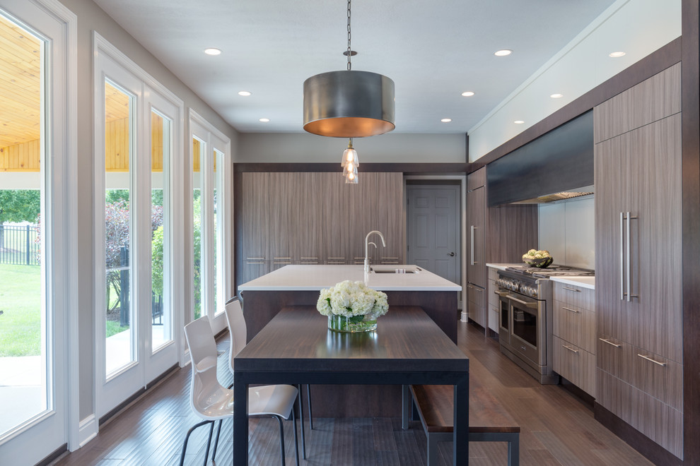 Contemporary eat-in kitchen in Other with an undermount sink, flat-panel cabinets, brown cabinets, stainless steel appliances, dark hardwood floors, brown floor and white benchtop.
