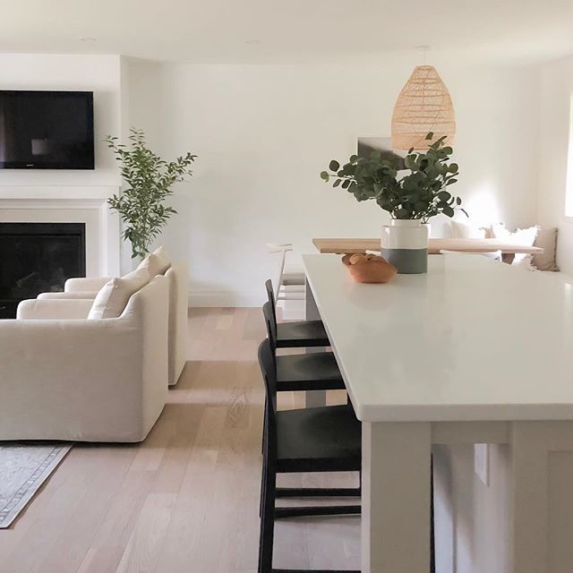 Design ideas for an expansive scandinavian open plan kitchen in Toronto with quartz benchtops, light hardwood floors, with island and white benchtop.