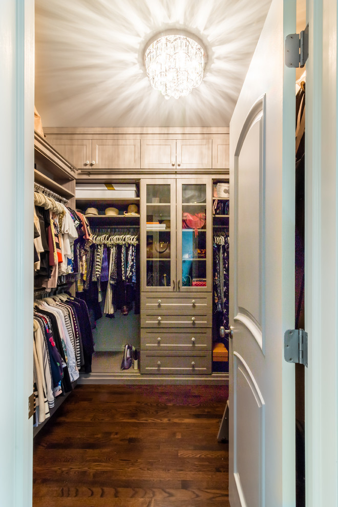 Inspiration for a transitional women's walk-in wardrobe in Boston with shaker cabinets, light wood cabinets, medium hardwood floors and brown floor.