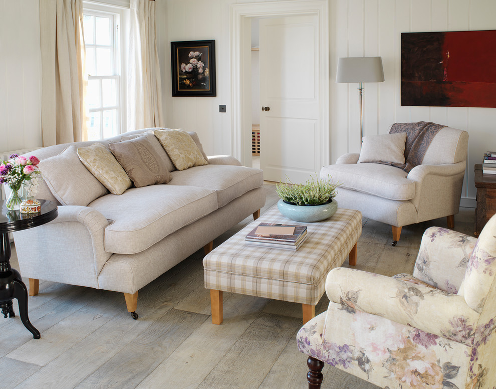This is an example of a traditional living room in Oxfordshire with white walls and light hardwood floors.