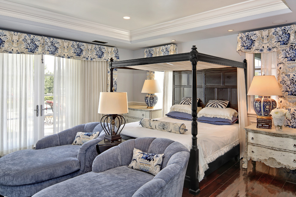 Design ideas for a large transitional master bedroom in Orange County with blue walls, dark hardwood floors and brown floor.