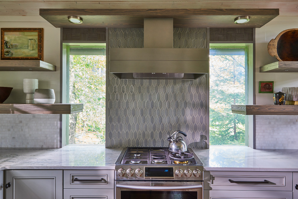 Small transitional single-wall medium tone wood floor, brown floor and vaulted ceiling eat-in kitchen photo with an undermount sink, recessed-panel cabinets, gray cabinets, granite countertops, multicolored backsplash, ceramic backsplash, stainless steel appliances, an island and turquoise countertops