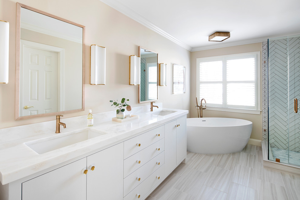 Transitional master white tile and ceramic tile ceramic tile and white floor freestanding bathtub photo in DC Metro with white cabinets, beige walls, an undermount sink, marble countertops, a hinged shower door and recessed-panel cabinets