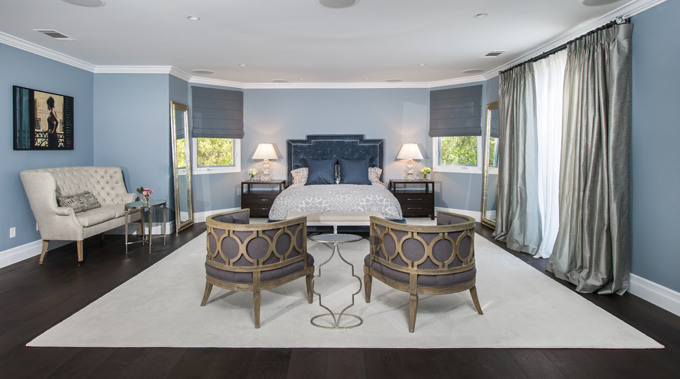 Inspiration for a large transitional master bedroom in Los Angeles with blue walls and dark hardwood floors.